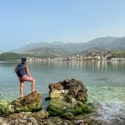 Woman overlooking clear waters of Himare, Albania