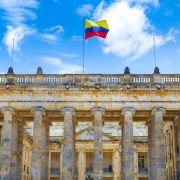 Colombia flag waving over historic building in Bogota